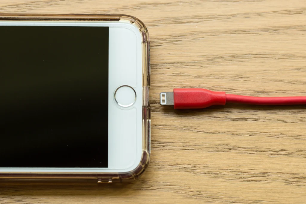 Why Is My iPhone Charging So Slow? Causes and Simple Fixes iPhone charging with charging cable